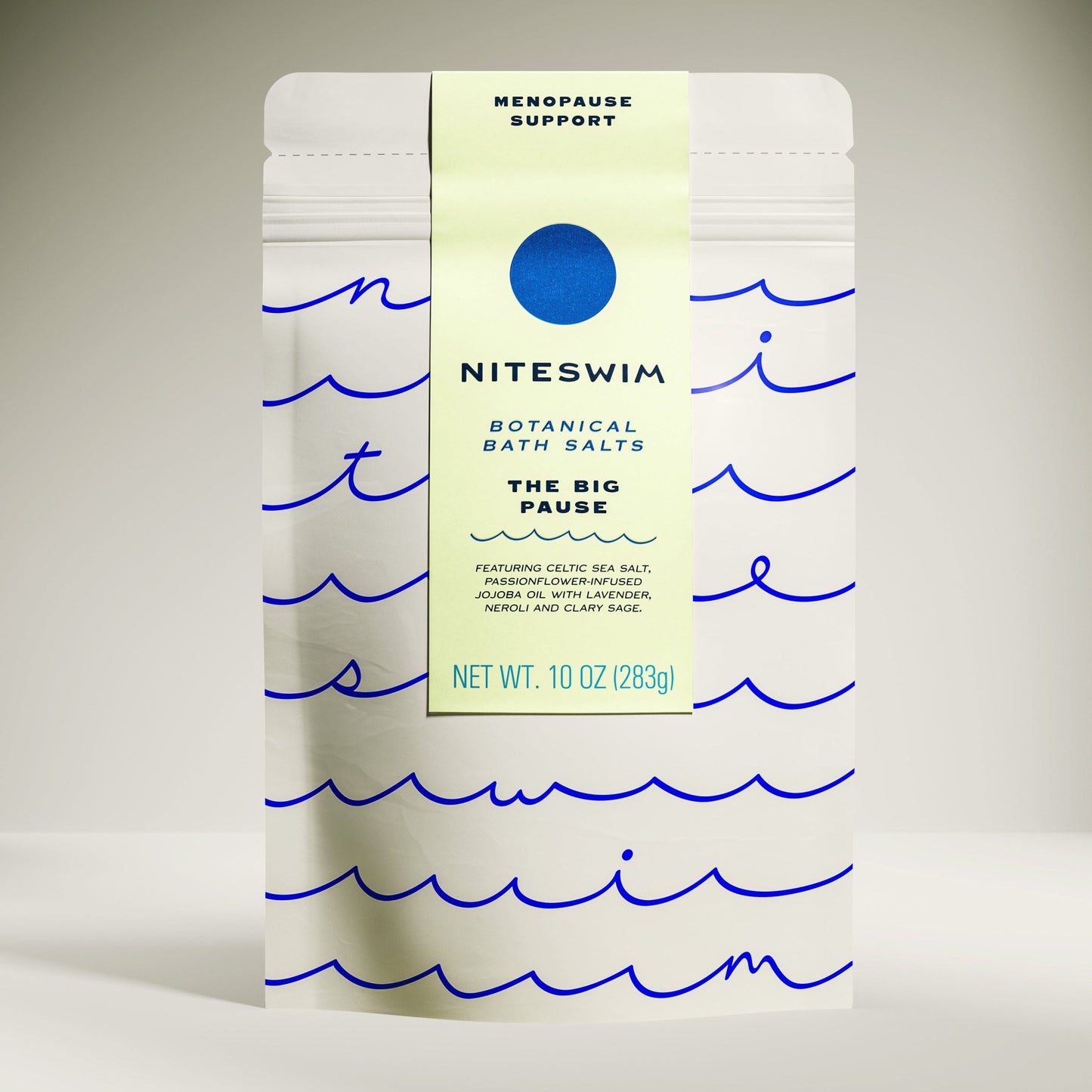 A package of 'Niteswim Botanical Bath Salts' with a label titled 'The Big Pause'. The package is white with blue wave patterns and text detailing the product's use for menopause support.