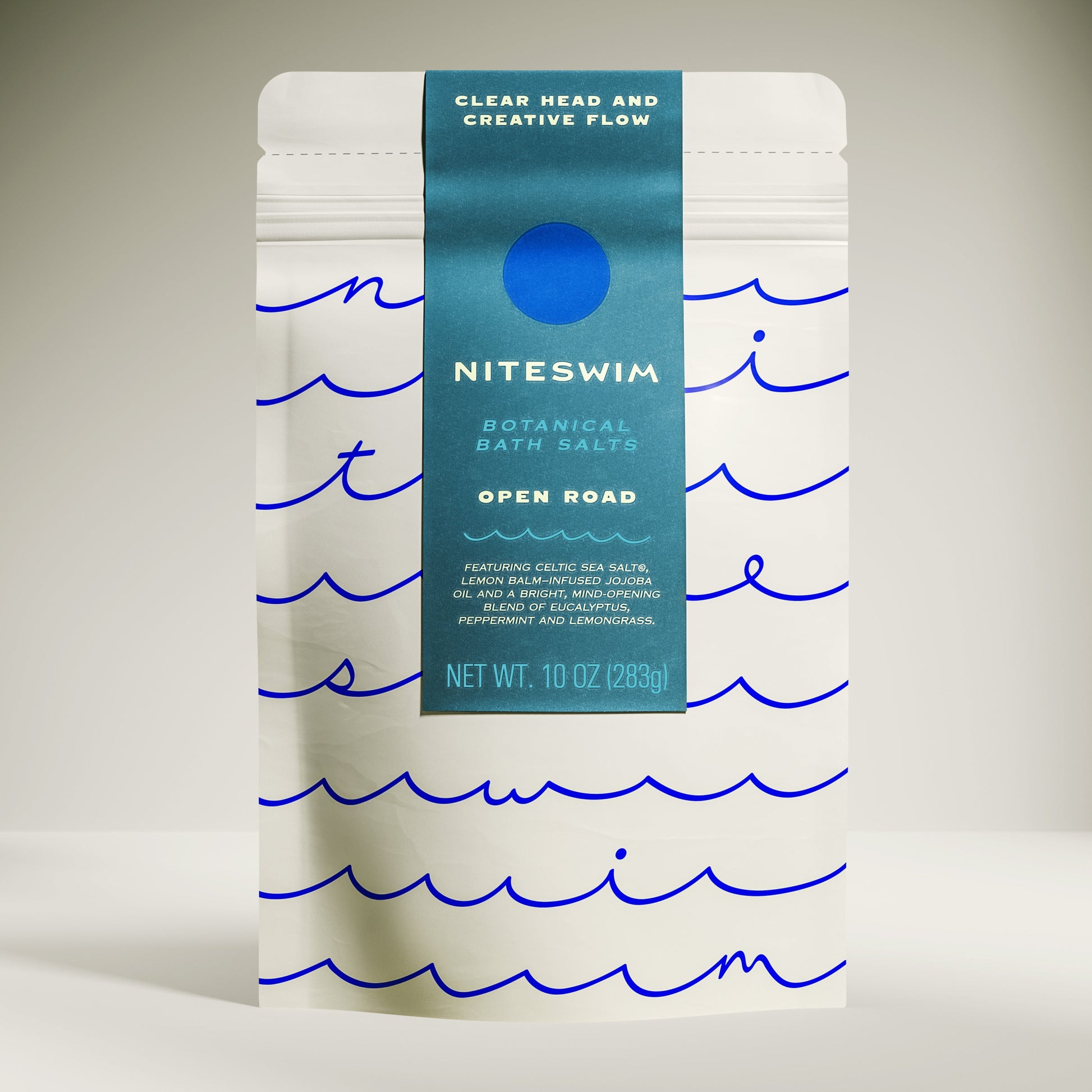Niteswim botanical bath salts packaging with wavy line design on a neutral background. Open Road bath blend for creativity and manifestation support.
