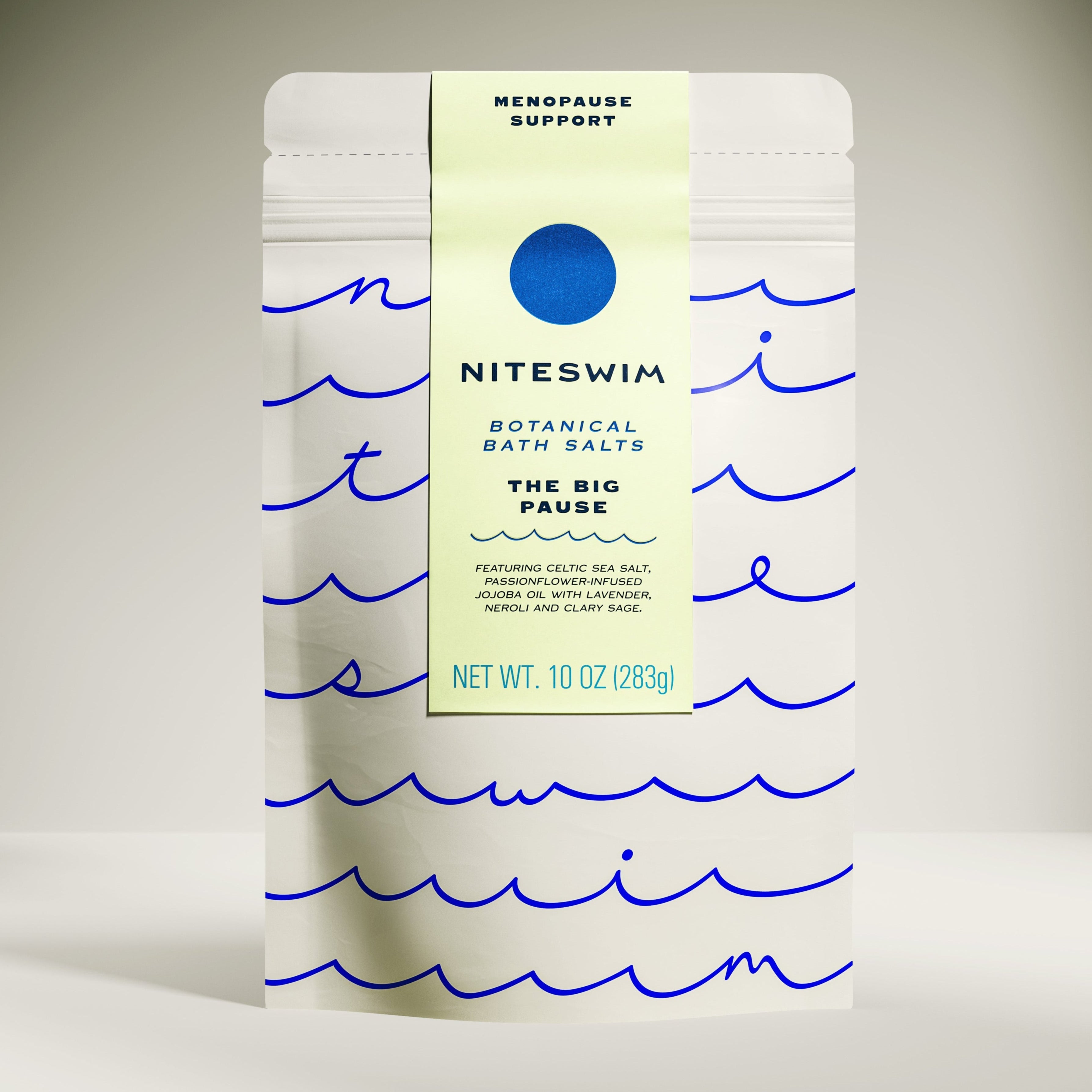 A package of 'Niteswim Botanical Bath Salts' with a label titled 'The Big Pause'. The package is white with blue wave patterns and text detailing the product's use for menopause support.