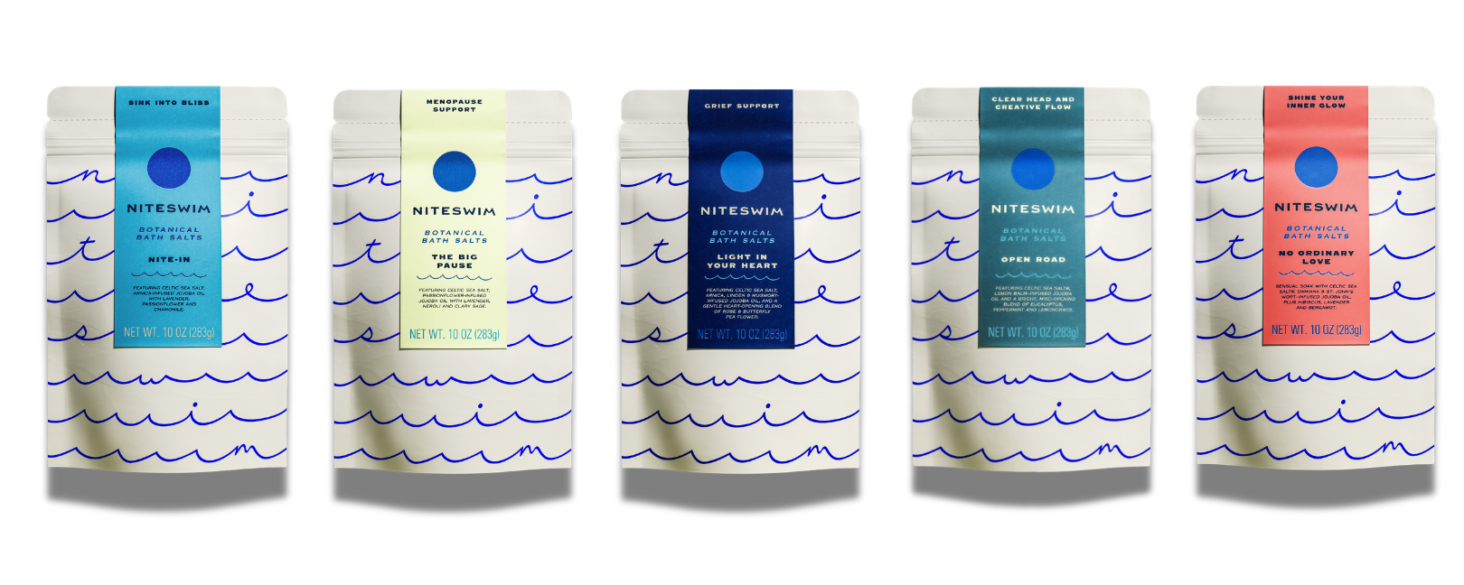Five bath salt packages with different colored labels on a white background